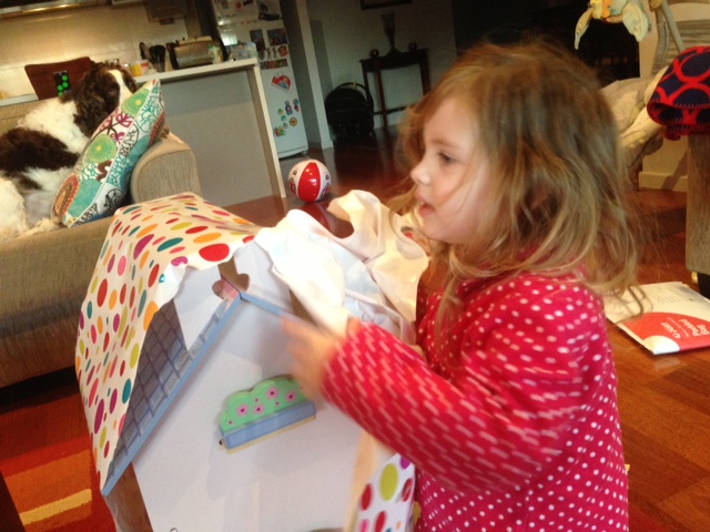Opening her big present from mum and dad - a dolls house