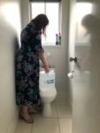 Pouring Water into Toilet Cistern