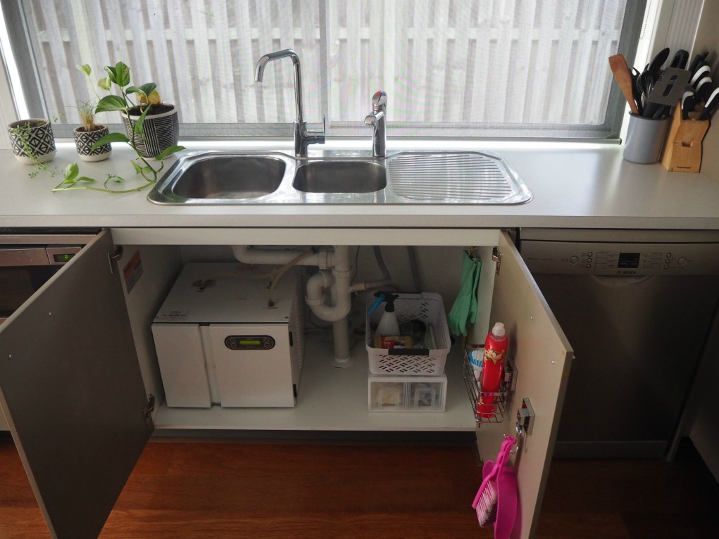 under kitchen sink showing cabinet