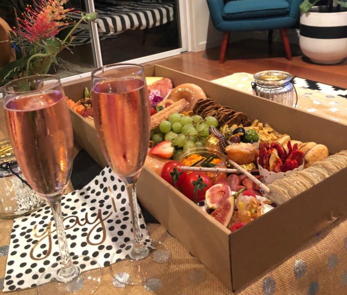 Our Date Night Picnic in The Living Room with grazing platter and champagne