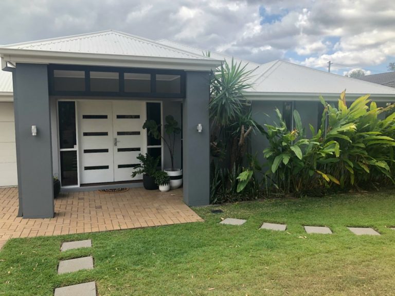Before and After of Our Painted Render Home
