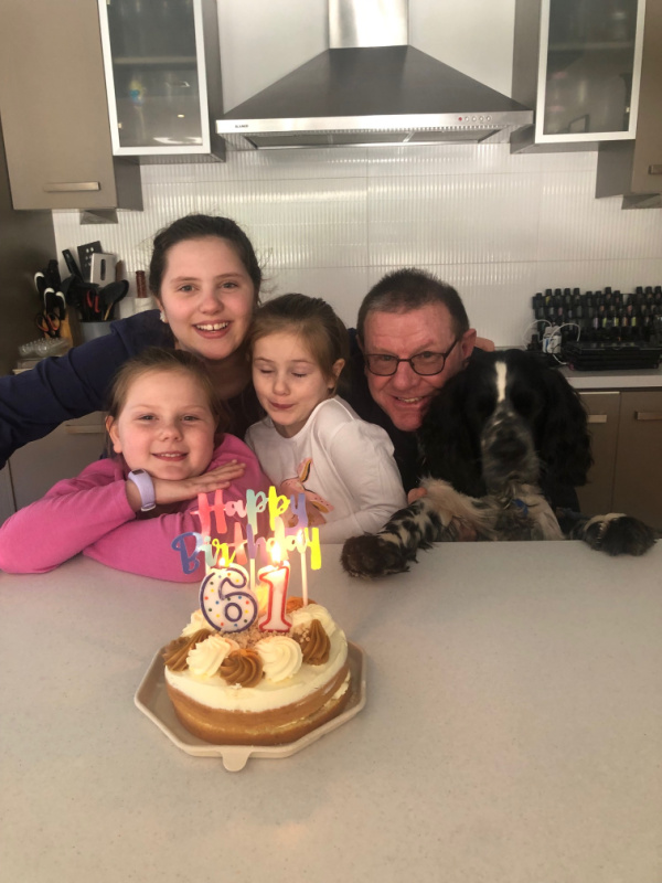 Dad celebrating 61st Birthday with grandchildren and puppy