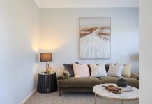 How to Buy the Right Amount of Paint for Your Next Project Coastal Australian Living room interior with couch, cushions and wall art. VJ panel walls with light grey paint