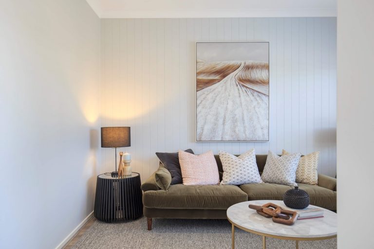 Coastal Australian Living room interior with couch, cushions and wall art. VJ panel walls with light grey paint